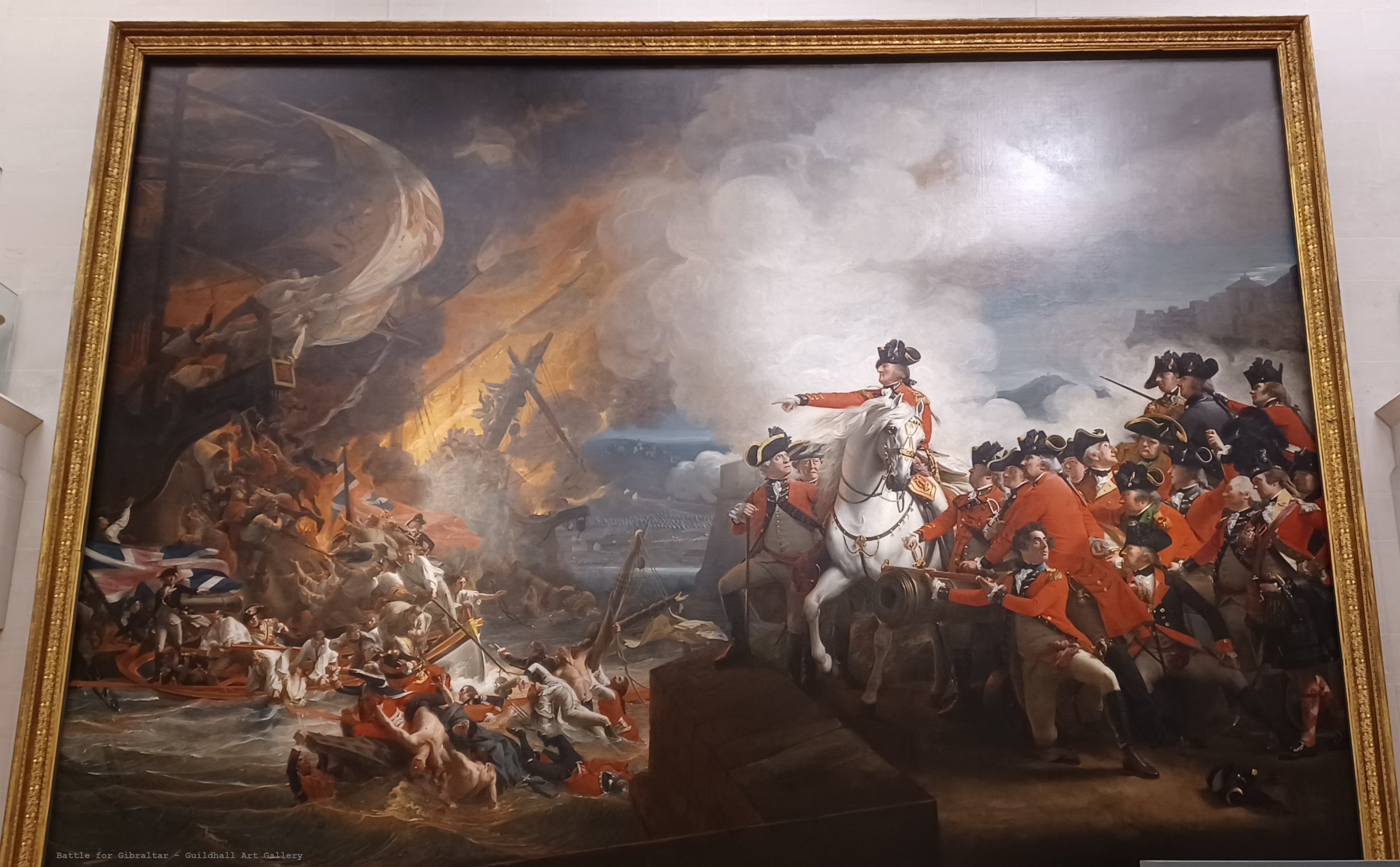 Magnificent fine art painting of The Battle for Gibraltar. You can see a lot of soldiers dying. Ships with cannons, fire, cannon balls, the British Flag. This painting is huge, it is the height of 2 adults and the width of a car.
