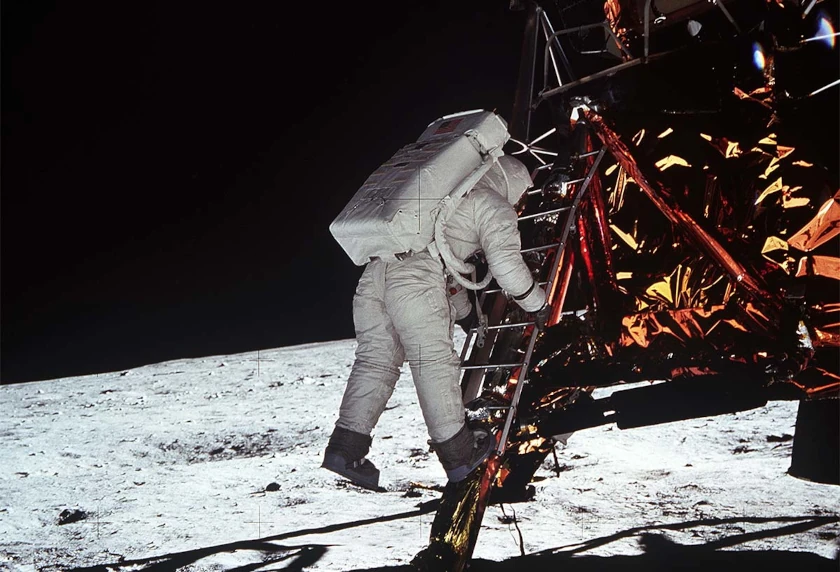 photo shows Buzz Aldrin descending from the lunar lander. He is going down the ladder, about to step onto the moon.