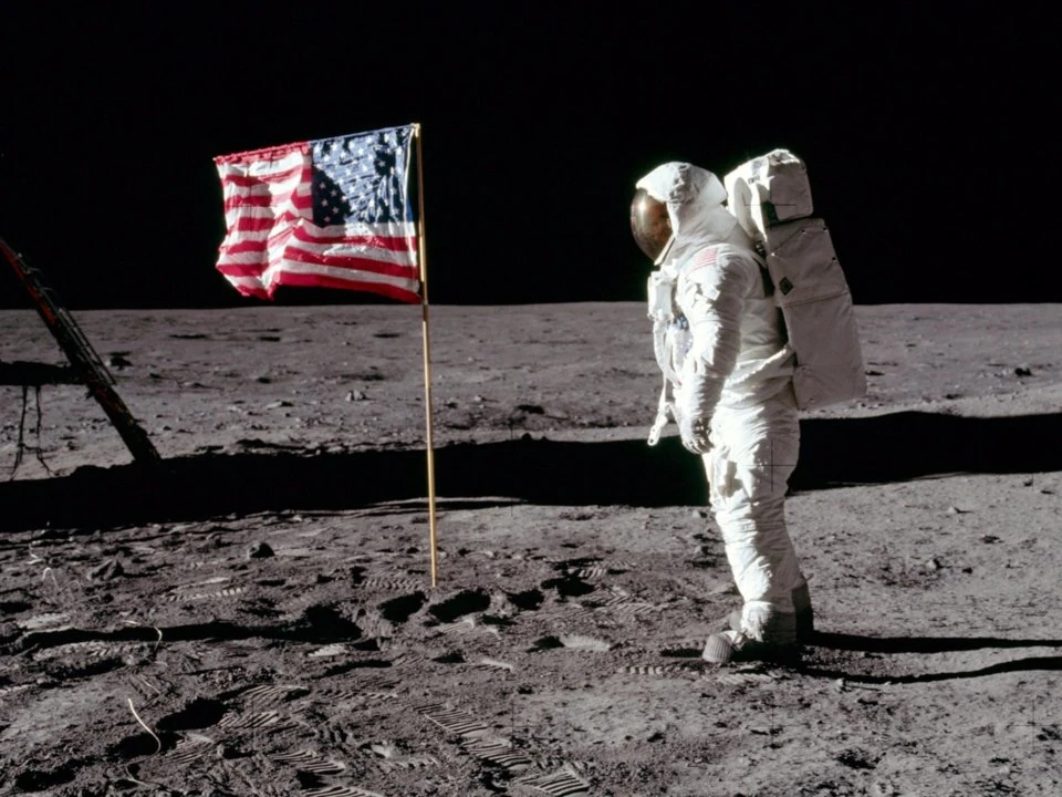 This photograpph shows Buzz Aldrin standing next to the American flag on the moon.