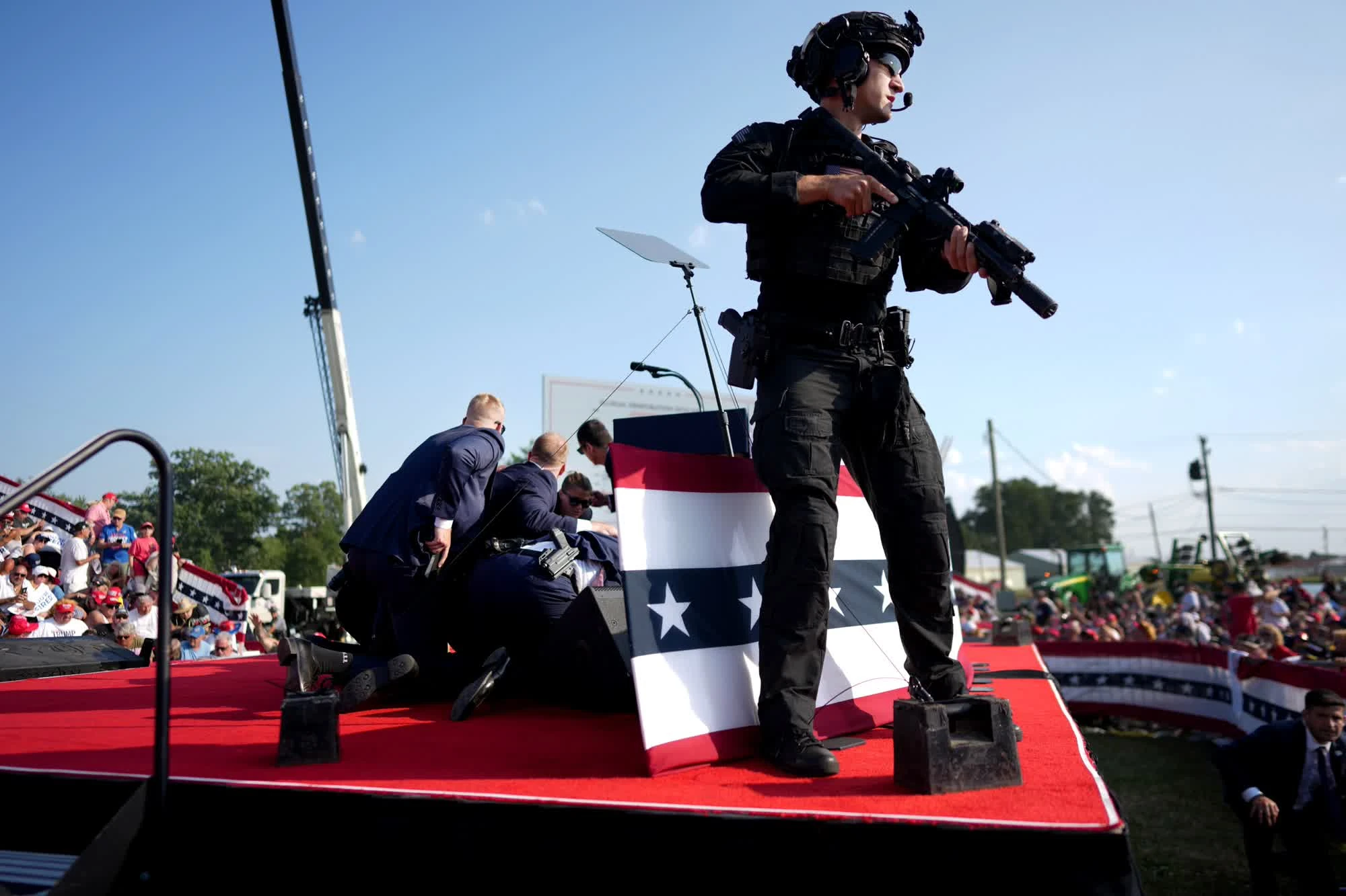 Photo shows armed bodyguards at the stage looking out for the shooter.