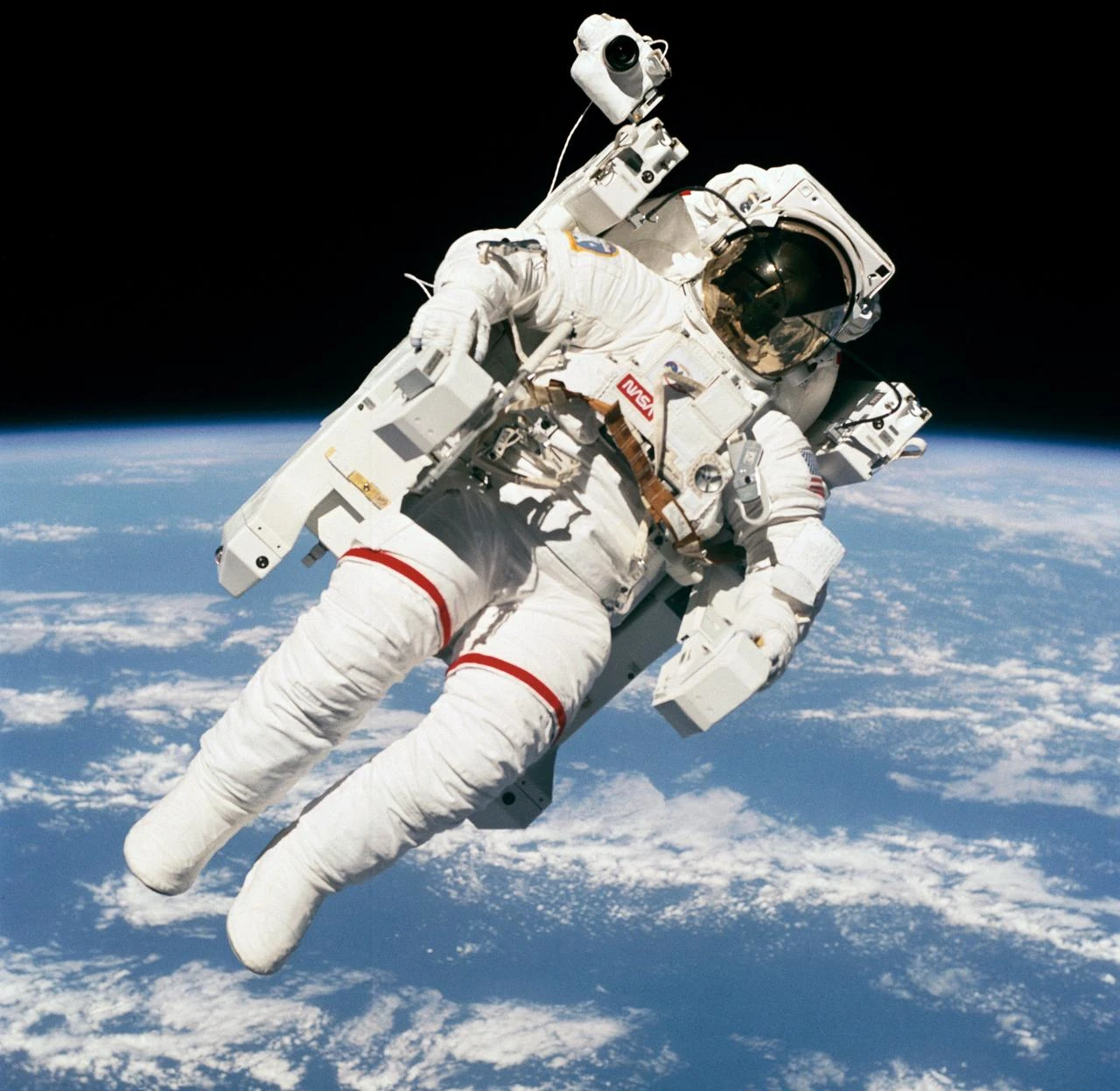 Photo shows astronaut Bruce McCandless II floating in space, a few meters away from the Space Shuttle Challenger.