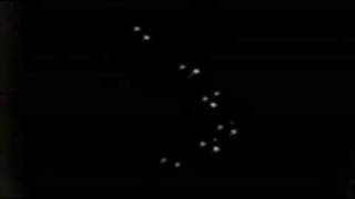 Photo shows lights in the sky flying in formation at night.