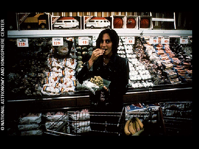 Photo shows a woman shopping in a supermarket